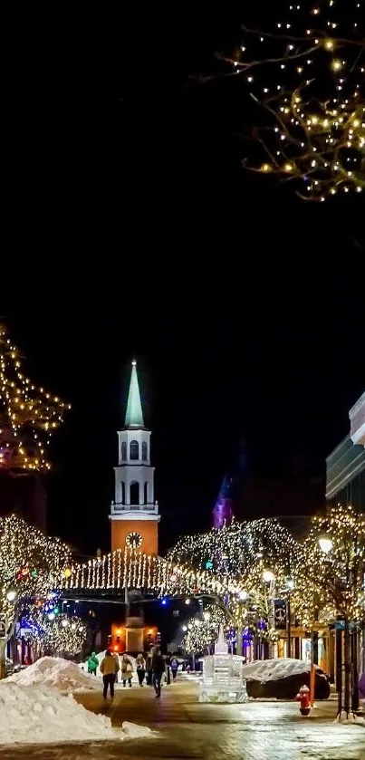 Festive night street with lights and snow-covered sidewalks.