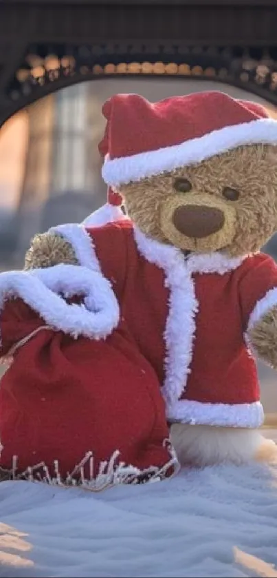 Teddy bear in Santa suit with Eiffel Tower backdrop.
