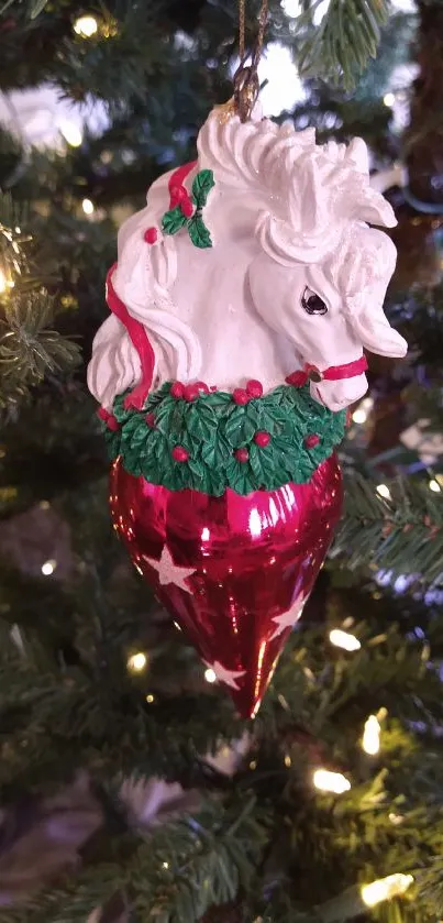 Unicorn Christmas ornament on a tree with lights.