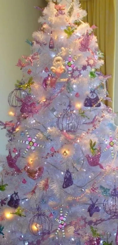 White Christmas tree with colorful ornaments and lights.