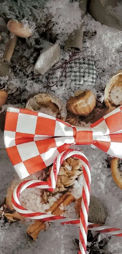 Red checkered bow with candy cane on snowy backdrop.