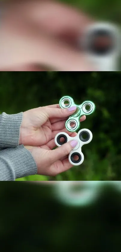 Hands holding a green fidget spinner against a blurred background.