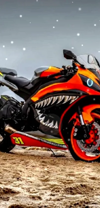 Vibrant orange motorcycle on a sandy beach with fierce shark design.