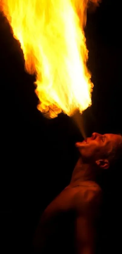 Mobile wallpaper of a firebreather exhaling vibrant orange flames.