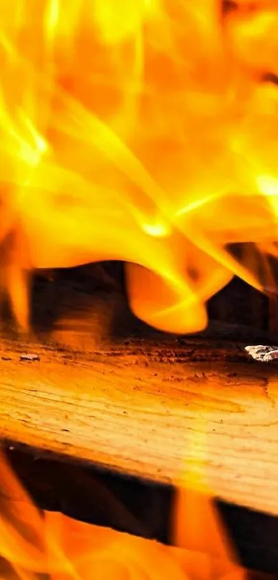 Fiery flames over wood, creating a warm and dynamic mobile wallpaper background.