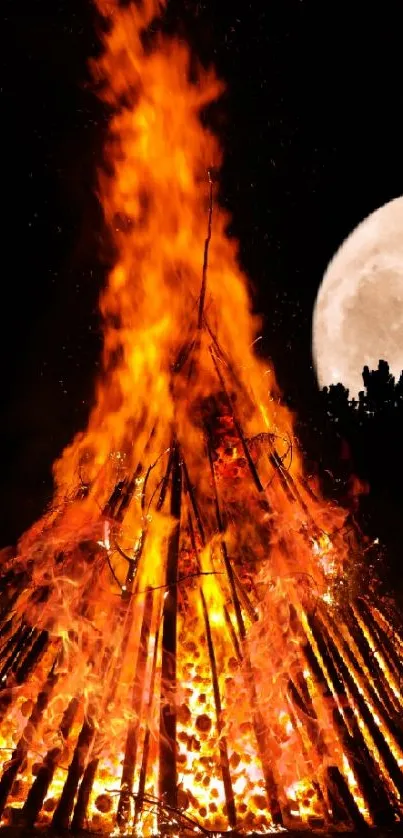 Bonfire blazing under a full moon in the night sky.