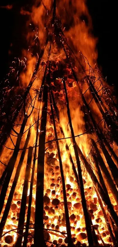 Dramatic bonfire emitting vibrant orange flames against a dark background.