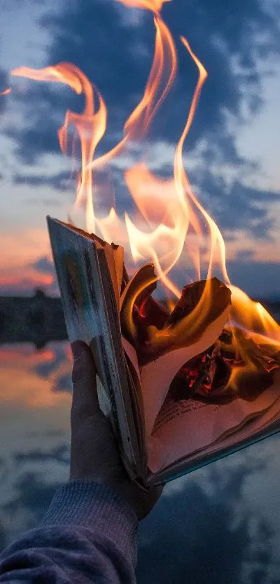 A burning book illuminates the night sky at dusk.