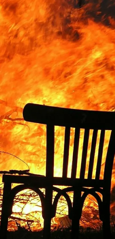 Silhouette of chair against bright orange flames.