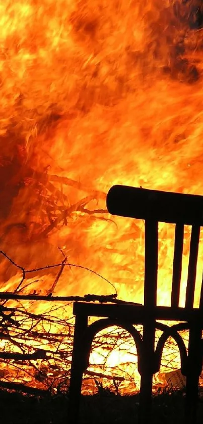 Silhouette of a chair against a blazing fire backdrop.