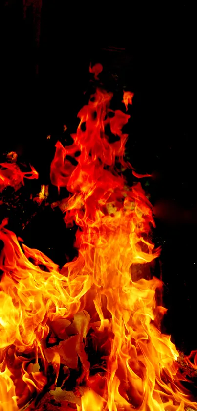 Vibrant orange flames wallpaper with dark background for mobile.