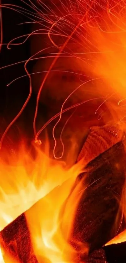 Close-up of vibrant orange flames and sparks on dark background