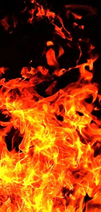 Bright fiery flames on a dark background, ideal as a mobile wallpaper.