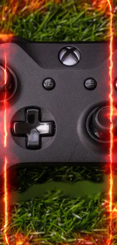 Black gaming controller with fiery effects on grass background.