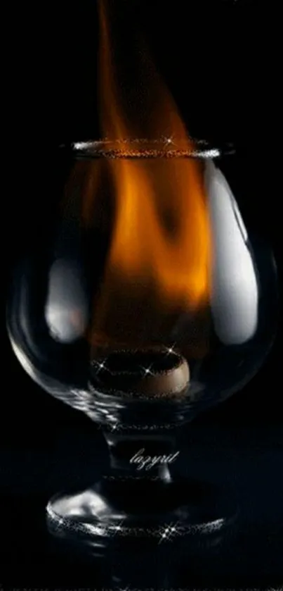 Glass with a bright flame against a dark backdrop.