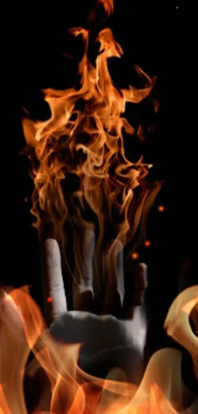 A hand engulfed in vibrant flames on a dark background.