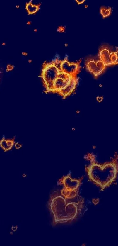 Fiery hearts in dark blue wallpaper with vibrant flames.