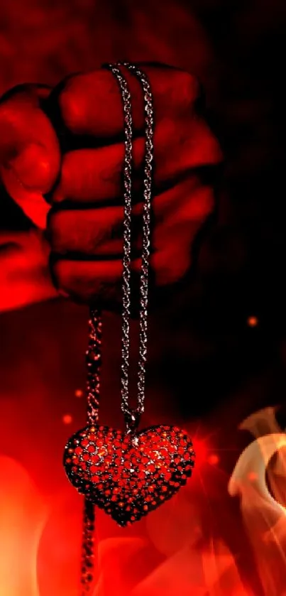 Fiery red heart pendant on a dark background held firmly.