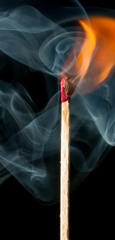 A burning matchstick with vibrant flame and swirling smoke on a dark background.