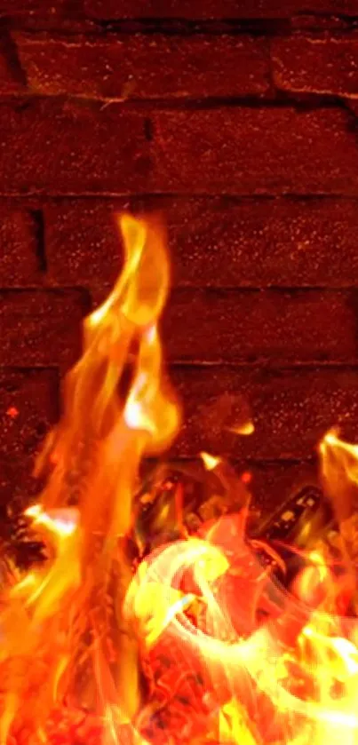 Mobile wallpaper with fiery flames against a brick wall.