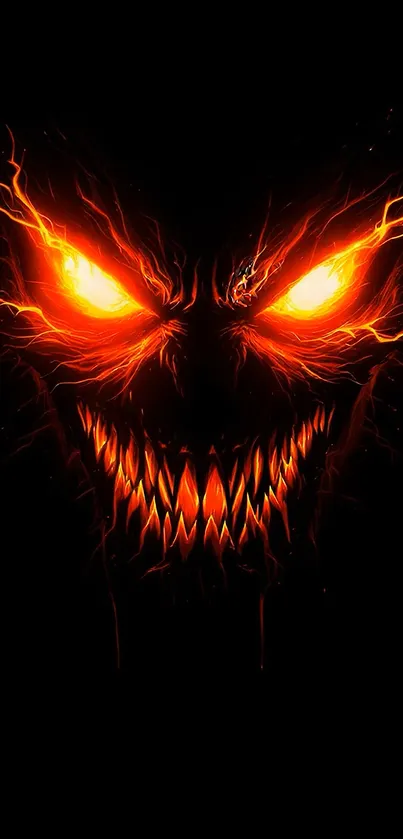 Fiery monster face with glowing eyes and sharp teeth on a black background.