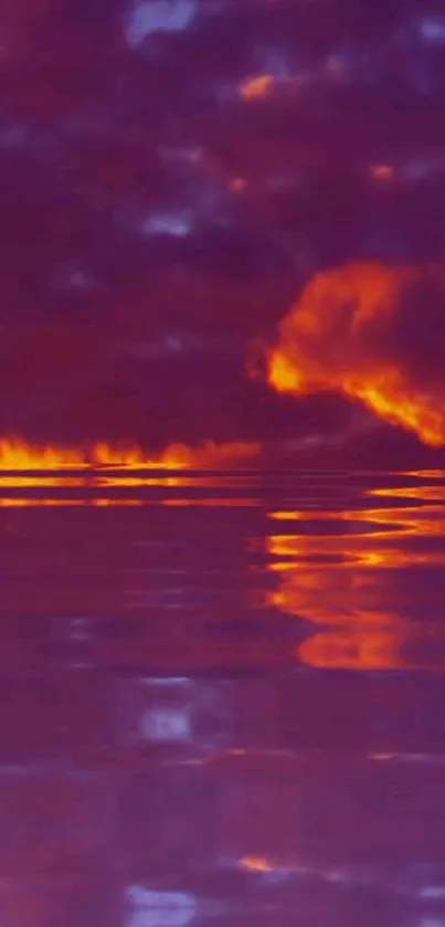 Fiery sunset over ocean with purple and orange hues, reflecting on the water.