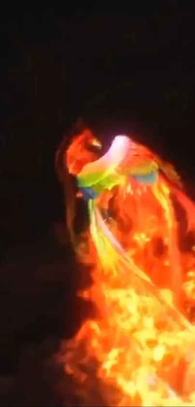 Fiery phoenix rising from flames on a dark background.