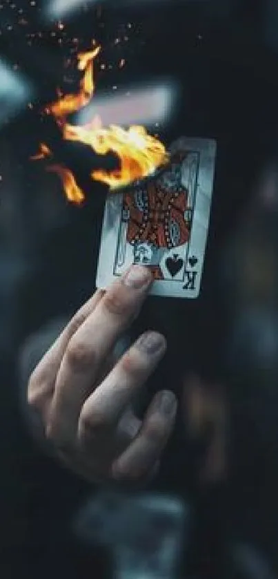 A playing card with flames in sharp focus against a dark background.