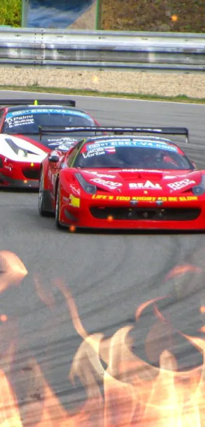 Two red racing cars on track with fiery effects.