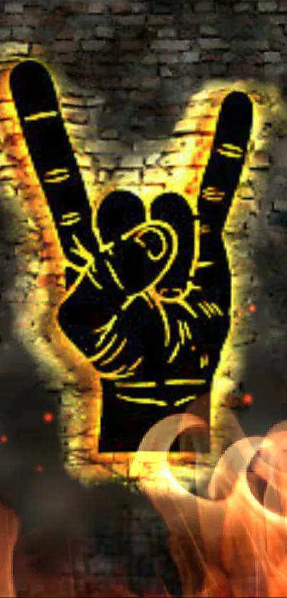 Rock hand gesture with fiery glow on brick background.