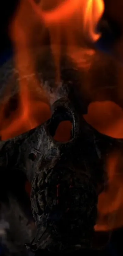 Wallpaper of a skull enveloped in fiery flames, set on a black background.