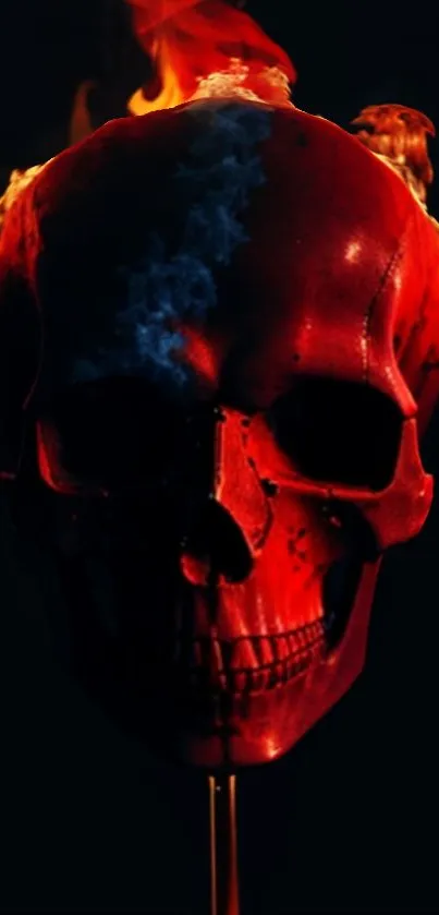 Fiery red skull with flames on a dark background wallpaper.