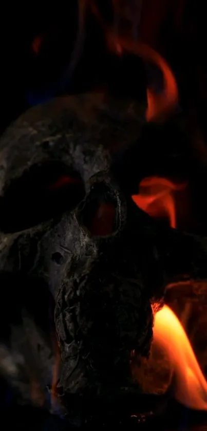 A dark skull surrounded by vivid orange flames.