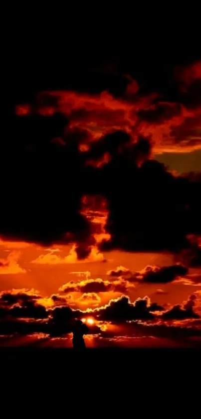Dramatic sunset with orange-red clouds on mobile wallpaper.