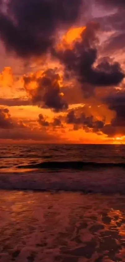 Fiery orange and purple sunset over ocean waves.