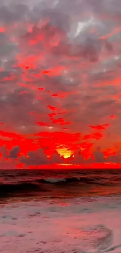 Fiery sunset with vibrant red sky over the ocean waves.