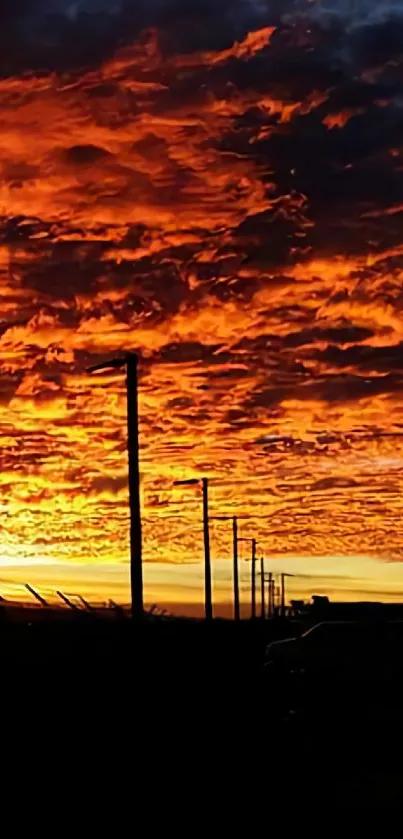 Vibrant orange sunset sky with dramatic clouds.