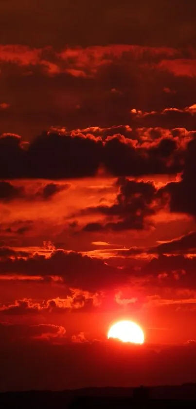 Fiery red sunset with clouds in the sky.