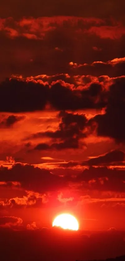 Fiery sunset sky with dark clouds and a glowing horizon.