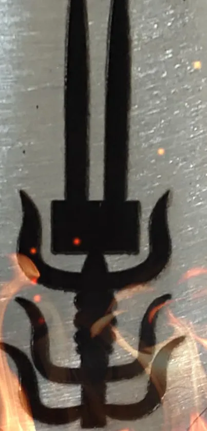 Black Trishula symbol with fiery accents on a metallic background.