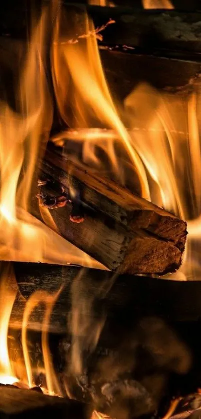 Orange and yellow flames over burning wood on a mobile wallpaper.