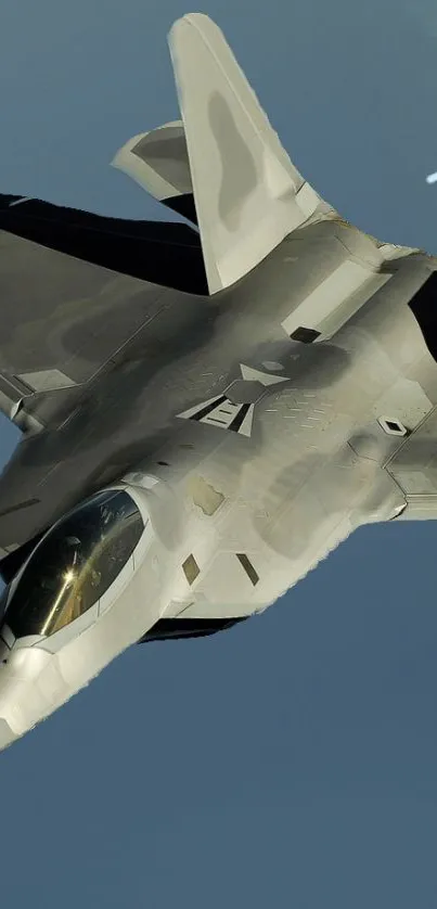 Fighter jet cruising through clear blue skies, showcasing its sleek, modern design.