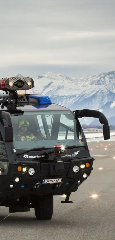 Fire truck navigating snowy mountain runway.