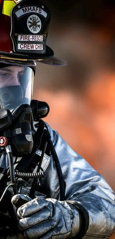 Firefighter wearing protective gear against fiery background.