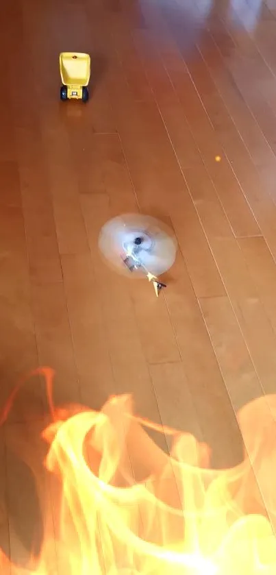 Toy truck on wooden floor with flames in the foreground.