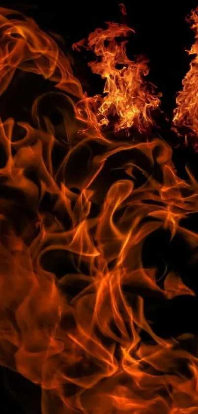 Dynamic orange flames on a black background wallpaper.