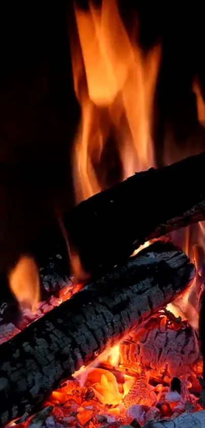 Mobile wallpaper of vivid orange flames over burning embers.