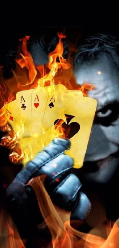 Joker holding flaming playing cards against a dark background.