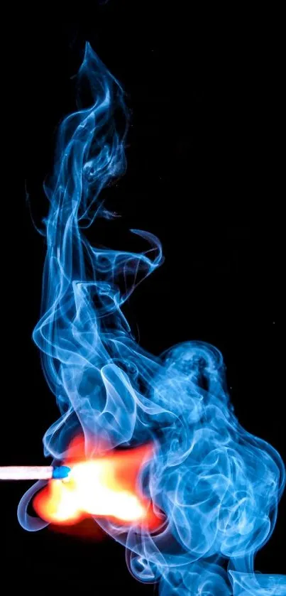 Vibrant flame with swirling blue smoke on a dark background, capturing dynamic motion.