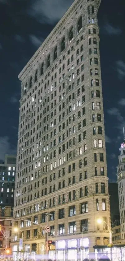 Night view of New York's Flatiron Building with city lights.